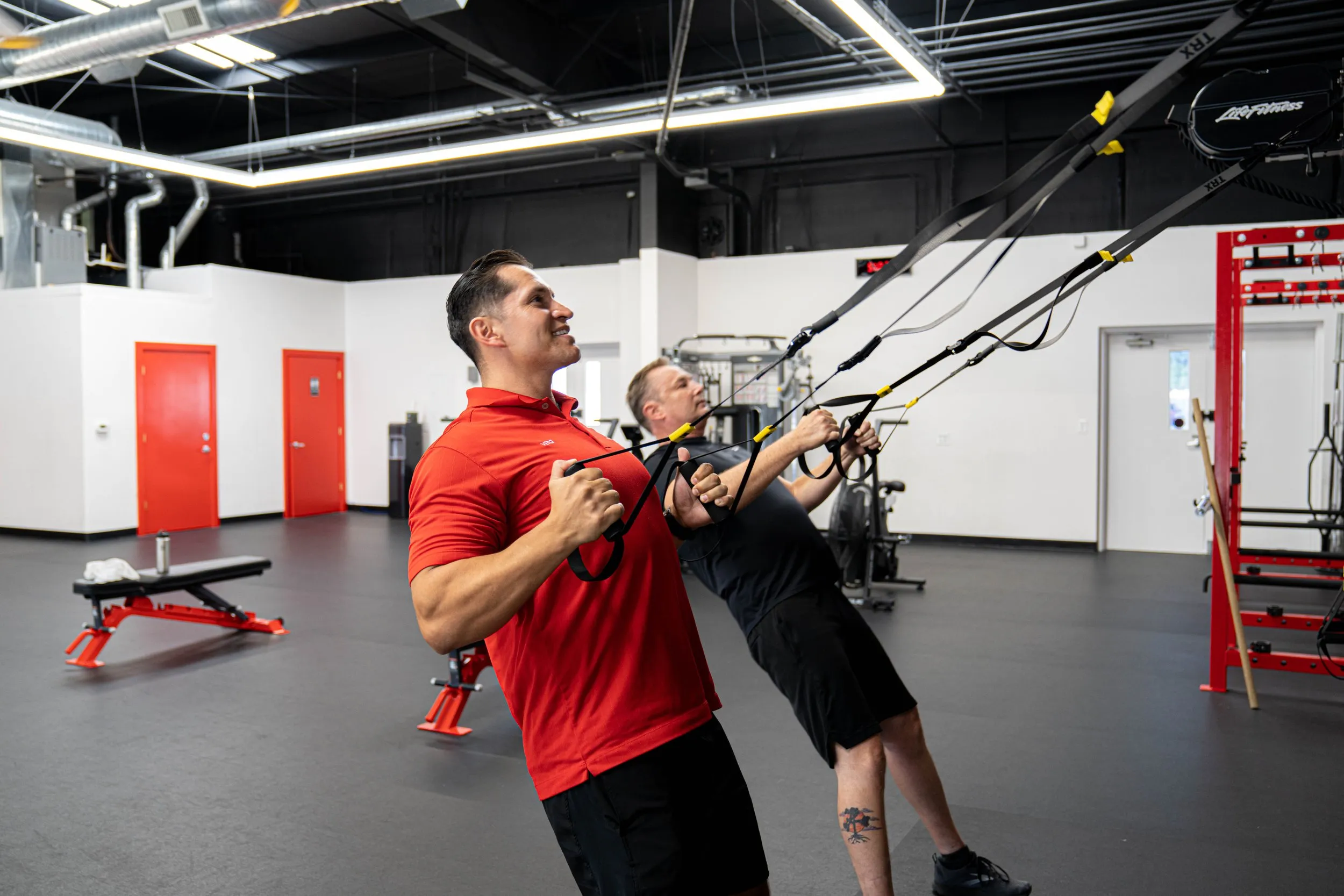 A trainer spotting a member during a one-on-one session